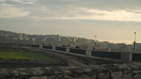 people enjoying the beautiful scenery of the peaceful city of budapest in hungary - wide pan