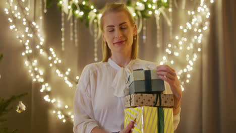 portrait of a happy woman holding presents in her hands