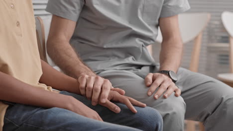 de las manos del médico calmando al paciente