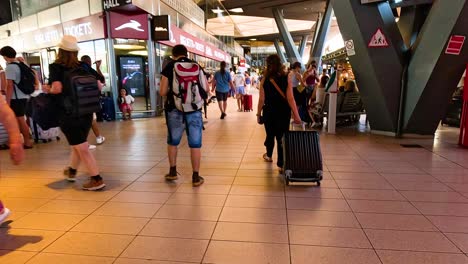 travelers navigating a bustling train station environment