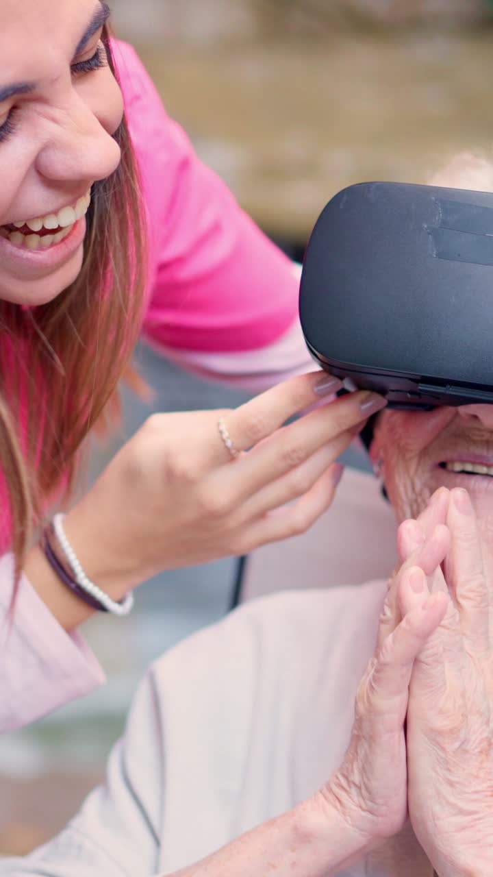 Elderly woman experiencing virtual reality with caregiver