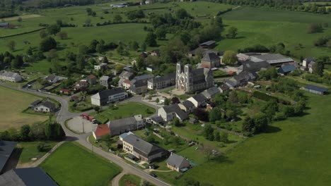 neuvizy village and church surrounded by vibrant green fields