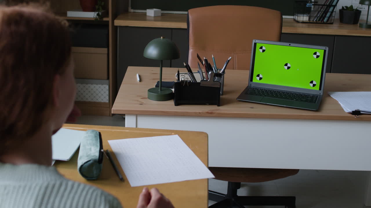 Student working on a laptop in a classroom