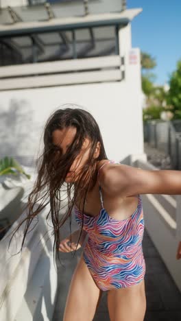 teenage girl in a colorful swimsuit