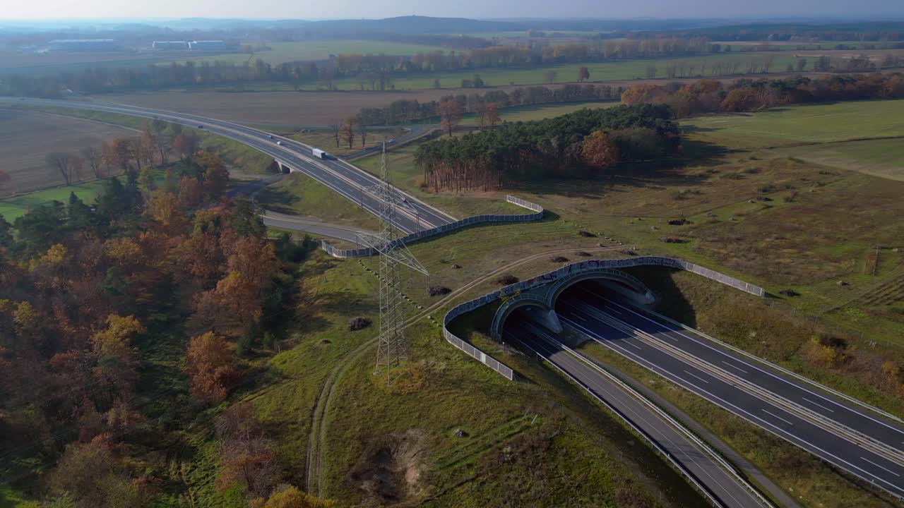 Ecoduct providing safe passage for wildlife over a german autobahn highway, seen from above. Breathtaking aerial view flight panorama orbit drone