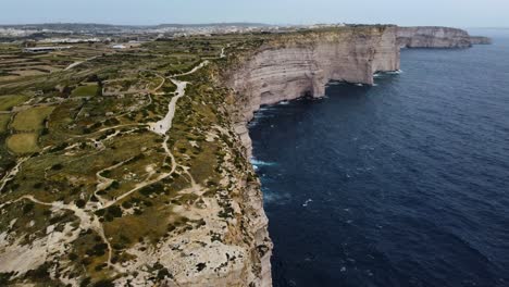 rocky coast cliff shoreline near sea ocean, green vegetation, flowers plants on highlands, limestone aerial drone overview shot