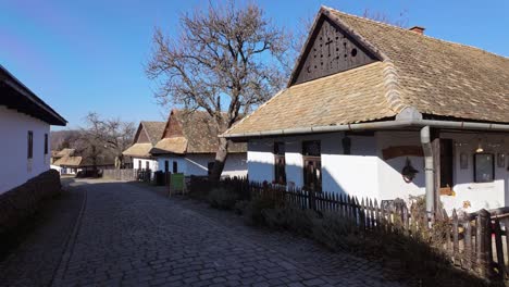 still life on the street of the old town of holloko with paloc type houses in on a sunny day in hungary.