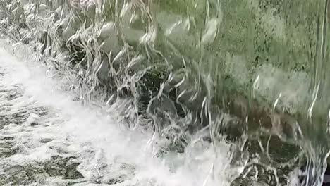 Close-up or fountain water drops to small pool in the city