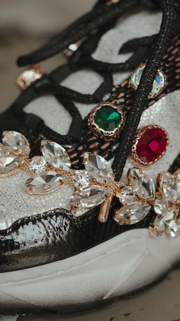 Vertical macro of jeweled designer shoe with crystals and gold detail