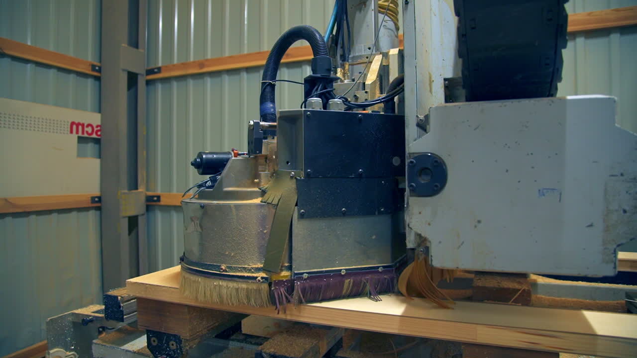 Polishing the wooden part of the future door. Automatic tool machine moves over the surface of timber plank.