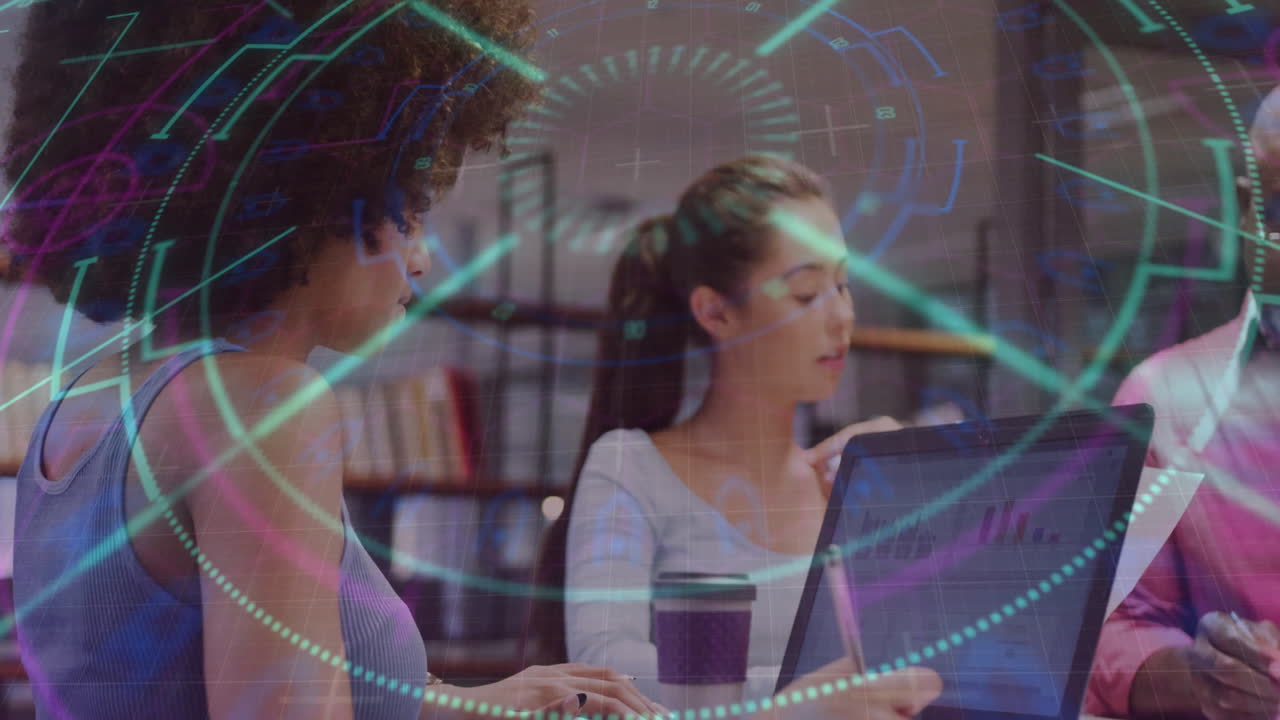 Colleagues collaborating in technology office, examining holographic graphs over laptops and papers