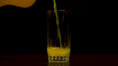 orange soda being poured into a glass