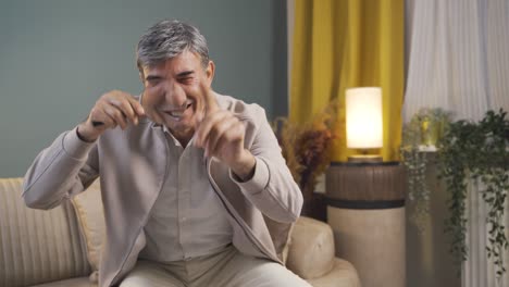 Old-man-looking-at-camera-with-magnifying-glass.