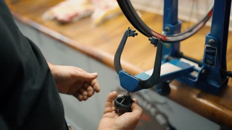 Wheel-straightening-stand-in-bicycle-workshop.Truing-bike-wheel