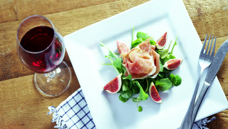 salad with red wine on wooden table