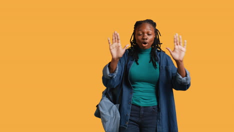 assertive woman doing stop hand gesture, studio background