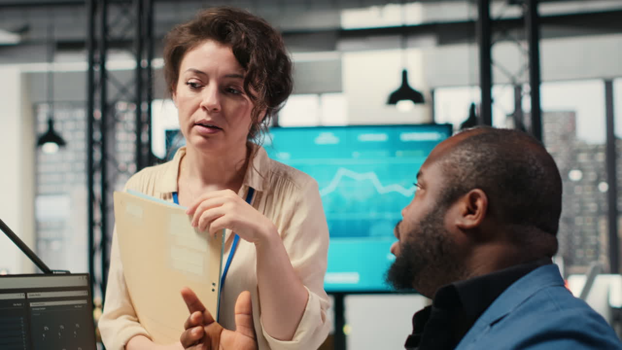 Vertical Video Colleagues engaging in discussion and consulting around performance metrics