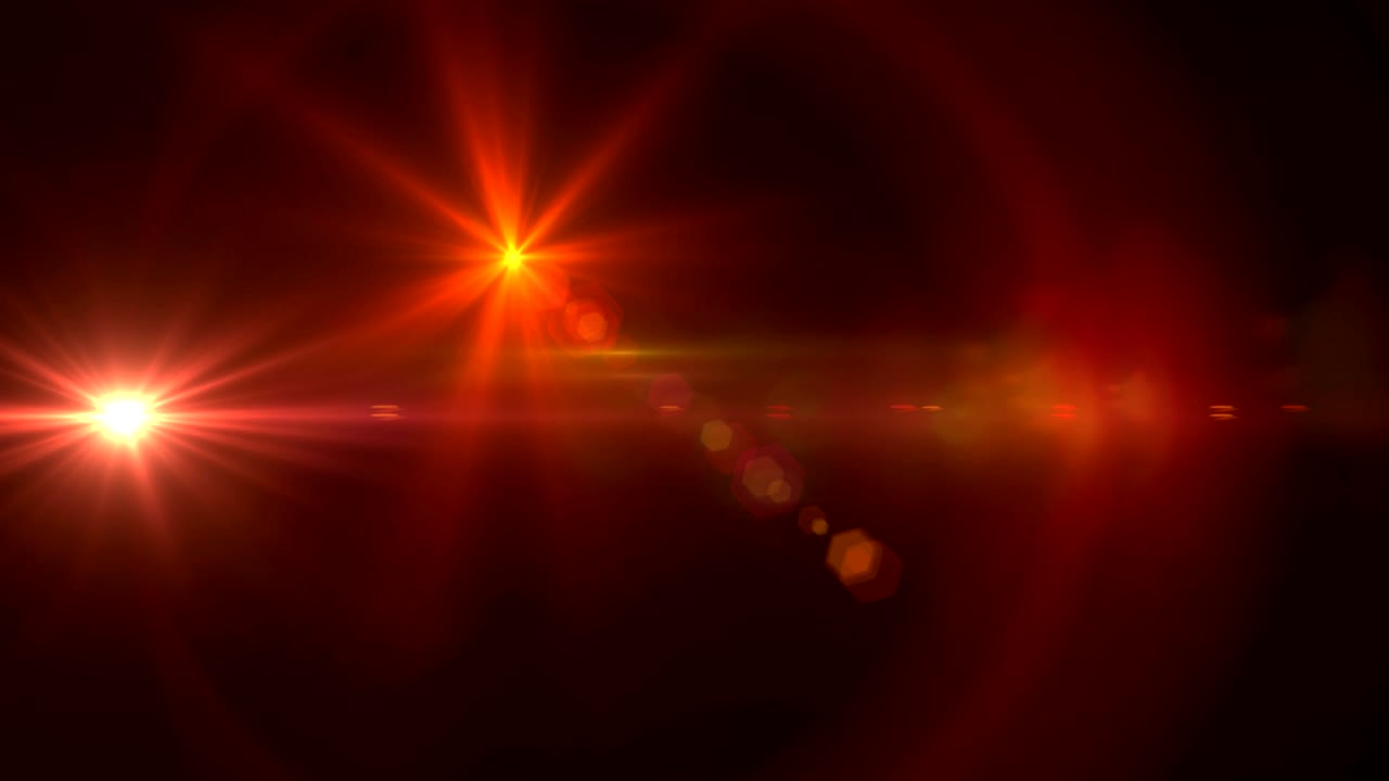 manchas rojas de luz contra un fondo negro