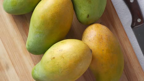 fresh mangoes on a cutting board