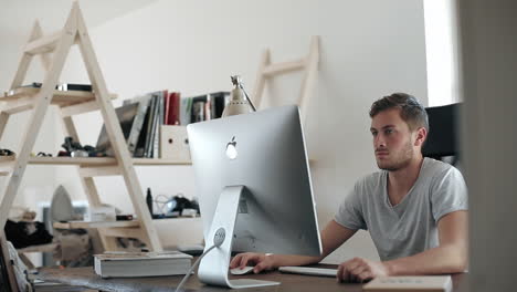 Man working on a computer in a modern home office