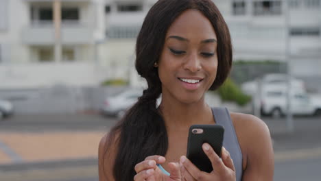 portrait sporty young black woman using smartphone enjoying browsing online messages texting on mobile app smiling satisfaction slow motion