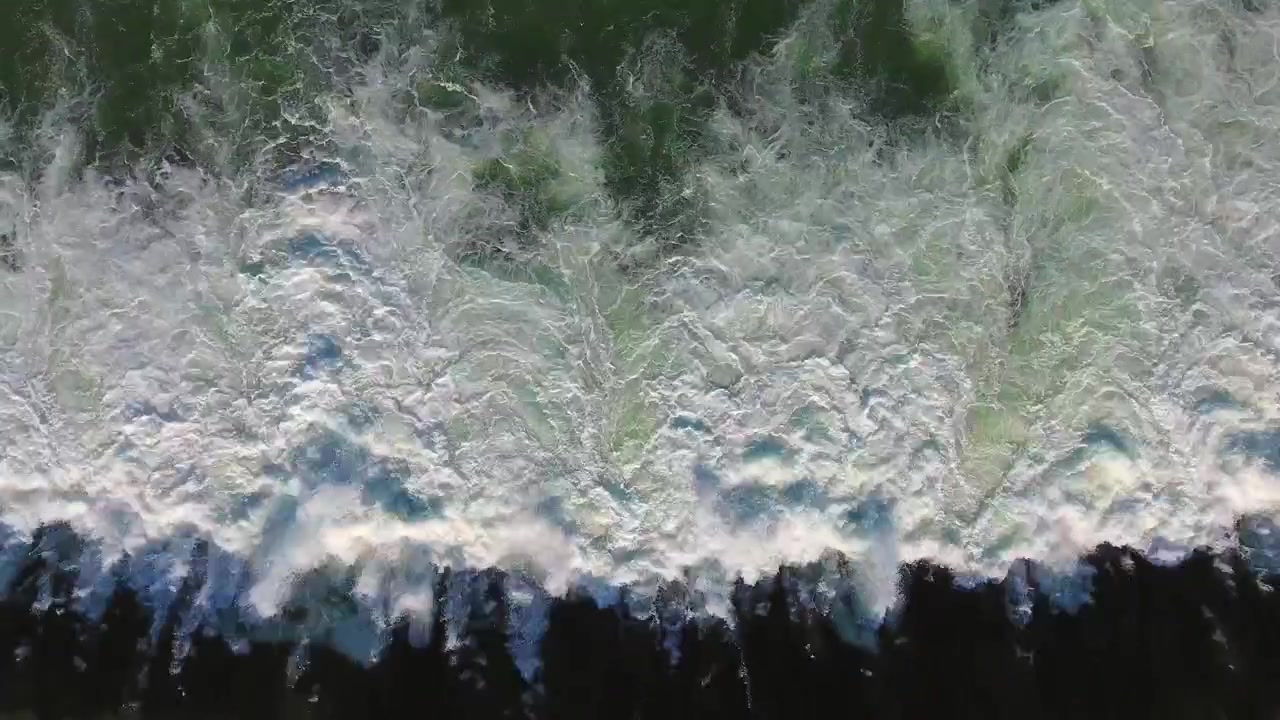 Aerial View of Ocean Waves Crashing on Shoreline
