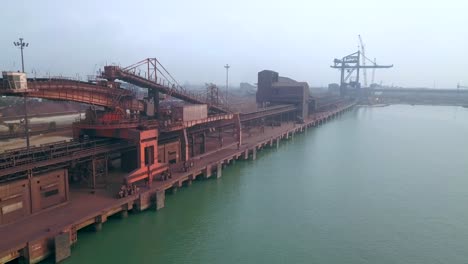 deep-water port on the coast of india in paradip with bulk ship loader machine at daytime