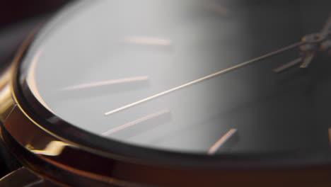 Macro-shot-of-a-minimalist-design-watch-with-the-arms-moving