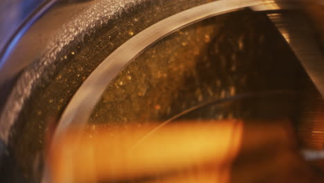 the beekeeper puts frames into honey production machine