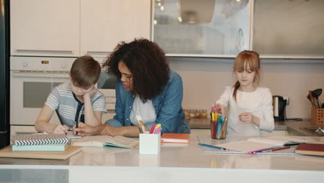 children doing homework in a kitchen