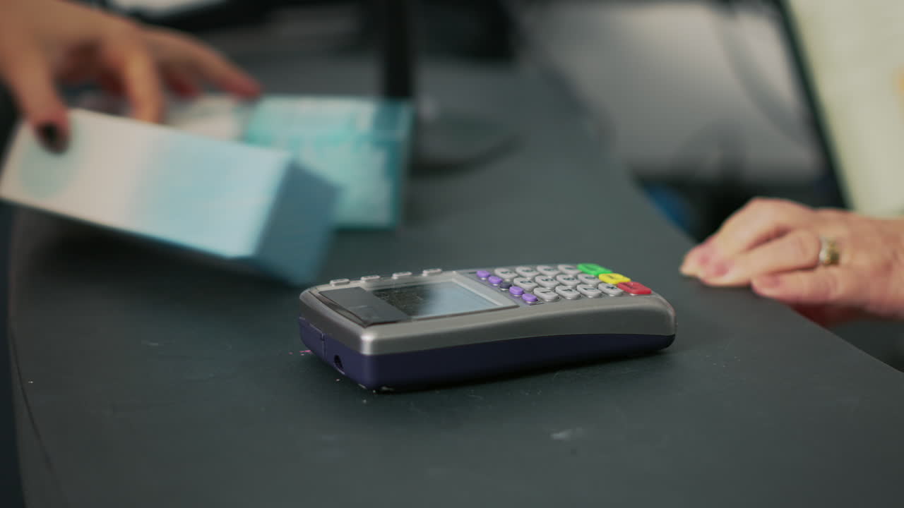 Images of a payment terminal being used in a business setting