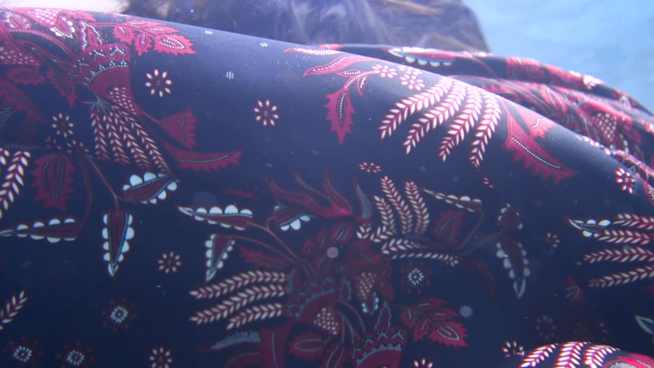 소녀의 어깨 위에 예술적으로 떠다니는 수중 패턴의 화려한 기모노