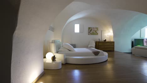 slow revealing shot of a open plan bedroom and living room with beautiful arches