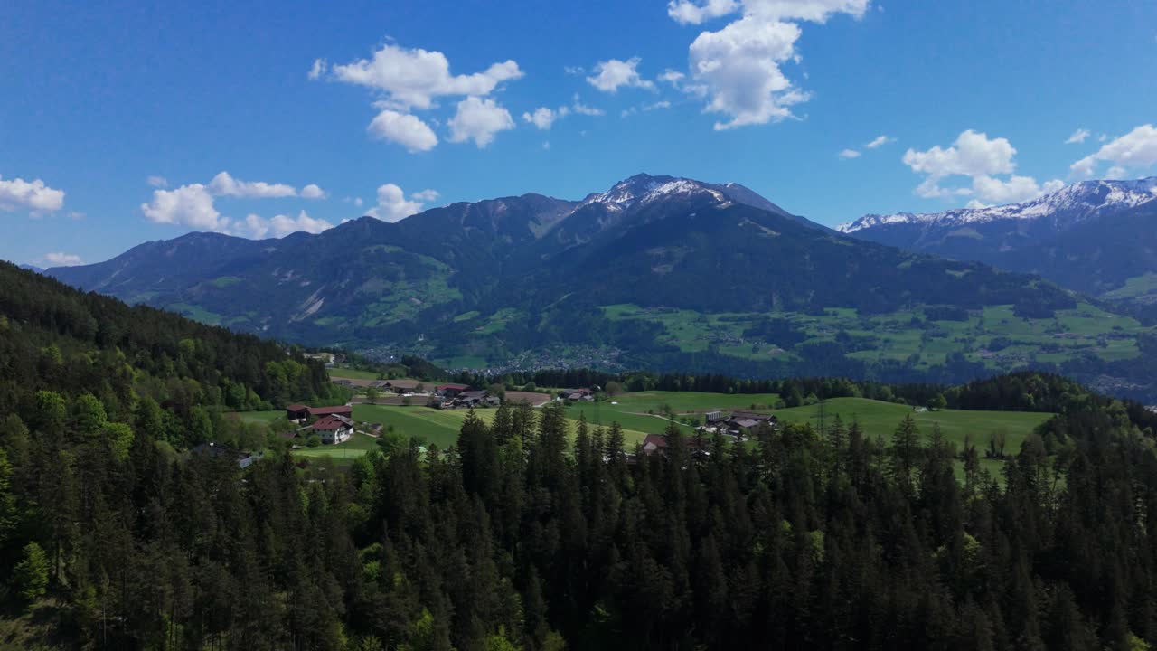 small village in the alps drone flight with blue sky in summer