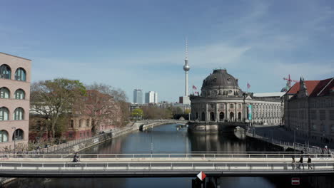 Antena:-Vista-Súper-Cercana-De-La-Parte-Superior-De-La-Torre-De-Televisión-Alexanderplatz-Con-Las-Calles-De-Berlín,-Alemania-En-Segundo-Plano-En-Un-Caluroso-Día-De-Verano