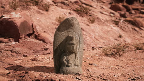 ancient statue on the rocks desert