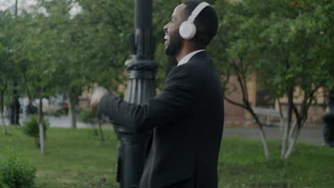 man with headphones in a city park