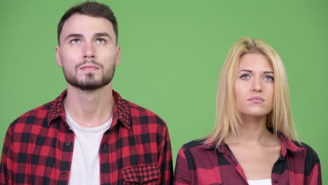 young couple looking up together