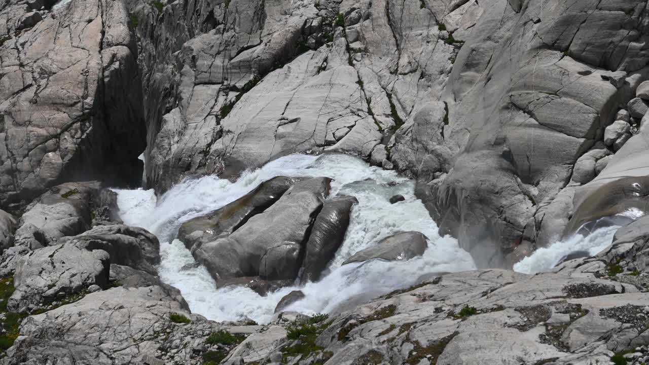 source of the rhone: small river at the top of the alps which crosses the rock and leaves the glacier, Switzerland