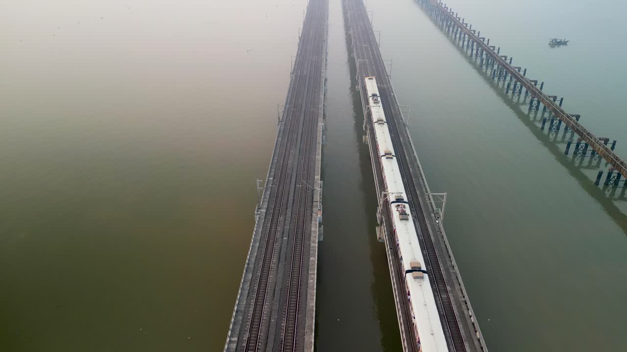 train going from bhayandar staton on vasai creek bridge wide bird eye view