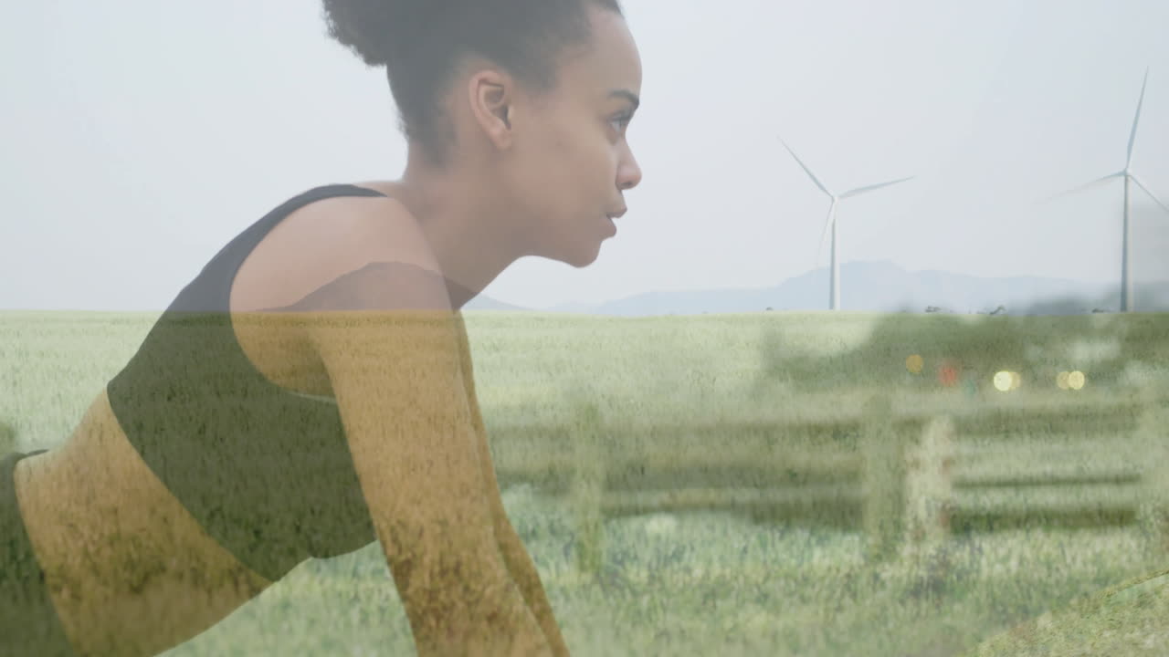 Exercising woman overlaid with animation of wind turbine in green field landscape