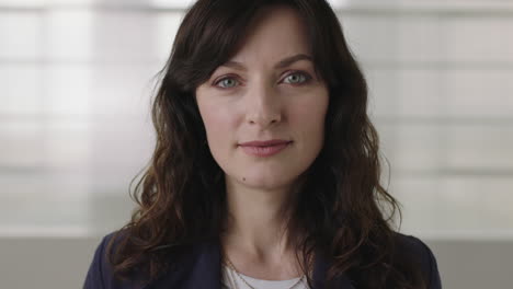 close up portrait of beautiful young business woman thinking pensive turns head looking at camera smiling confident successful female executive