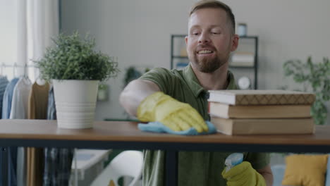 man cleaning a home shelf