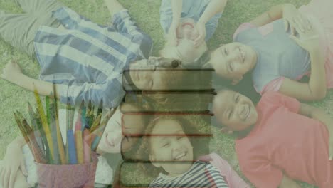 animation of stack of books moving over happy school children lying on grass