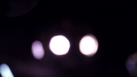 Blur-close-up-shot-of-spinning-party-lights-at-night-in-real-time