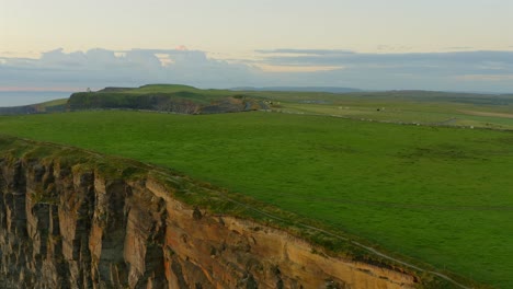 Pan-shot-transitions-from-fields-to-breathtaking-views-of-cliffs-and-ocean