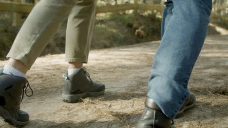 closeup of young couple walking along dirt path in national park