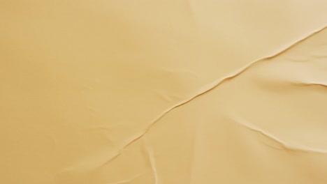 Video-of-close-up-of-yellow-creased-fabric-with-copy-space