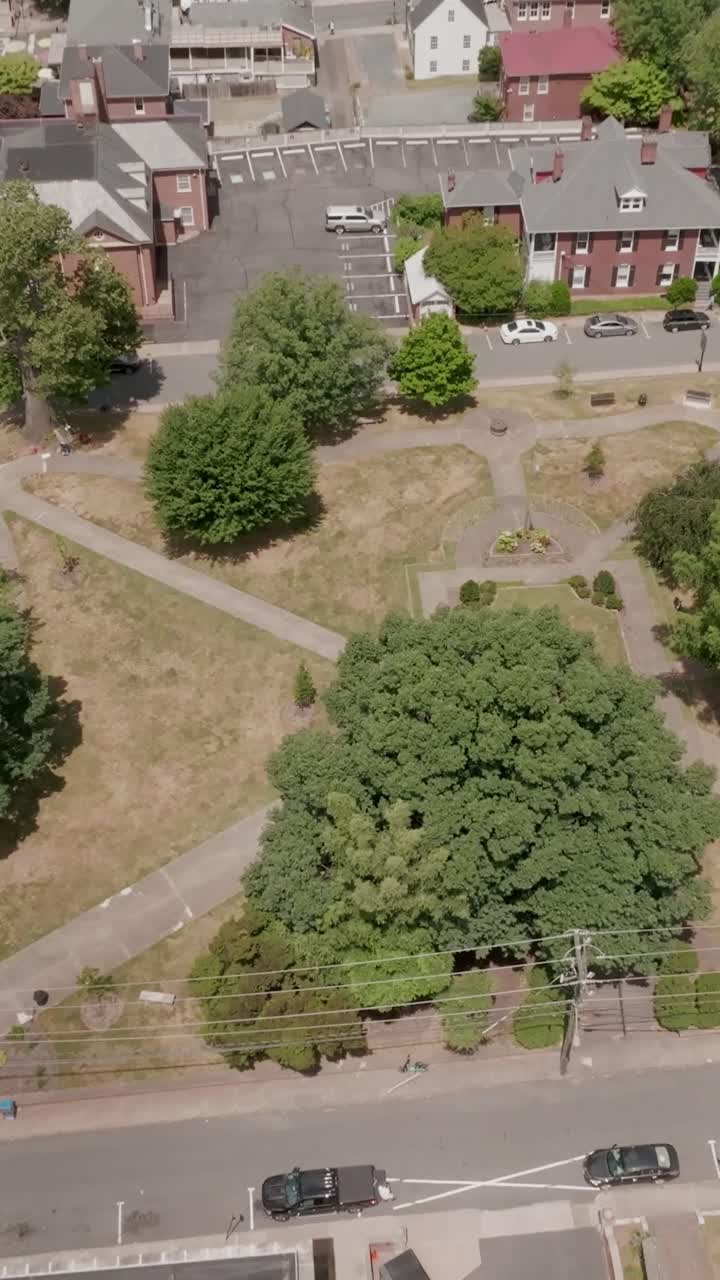 Vertical aerial drone looking down while pushing in over Market Street Park in Charlottesville Virginia showcasing downtown layout and urban environment in daylight