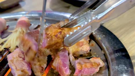 detailed view of skewered meat and mushrooms grilling on a tabletop grill, showcasing vibrant textures and colors.